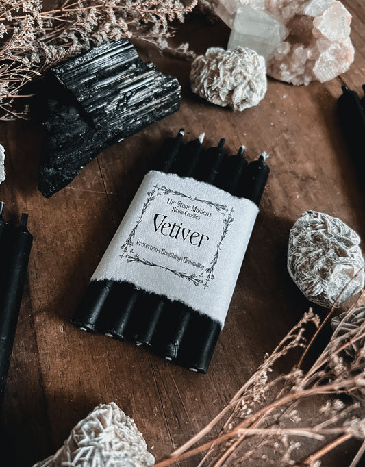 Vetiver Black  ritual candles arranged on a dark wooden altar surrounded by crystals, sold at The Stone Maidens