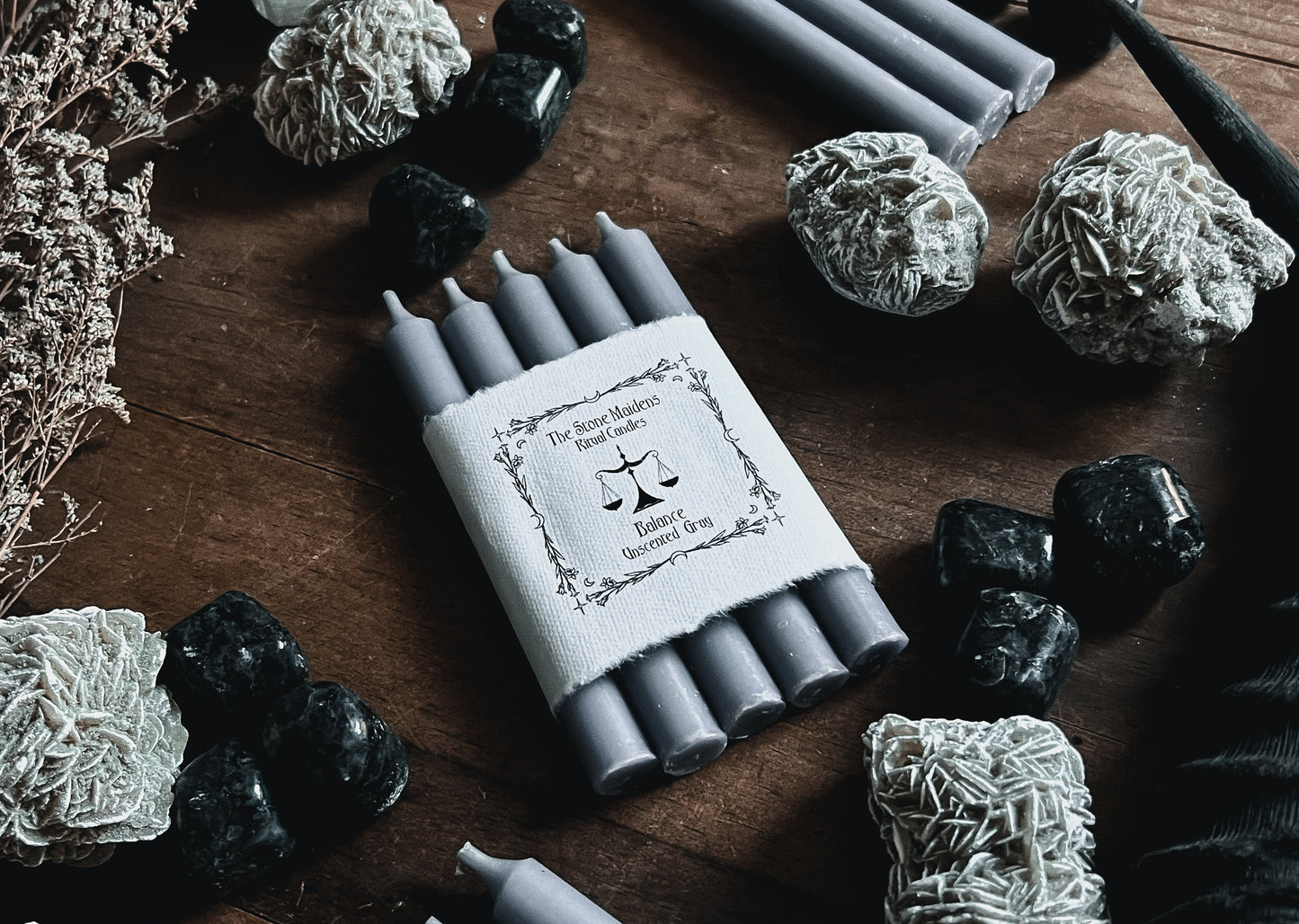 unscented grey ritual candles arranged on a dark wooden altar surrounded by crystals, sold at The Stone Maidens