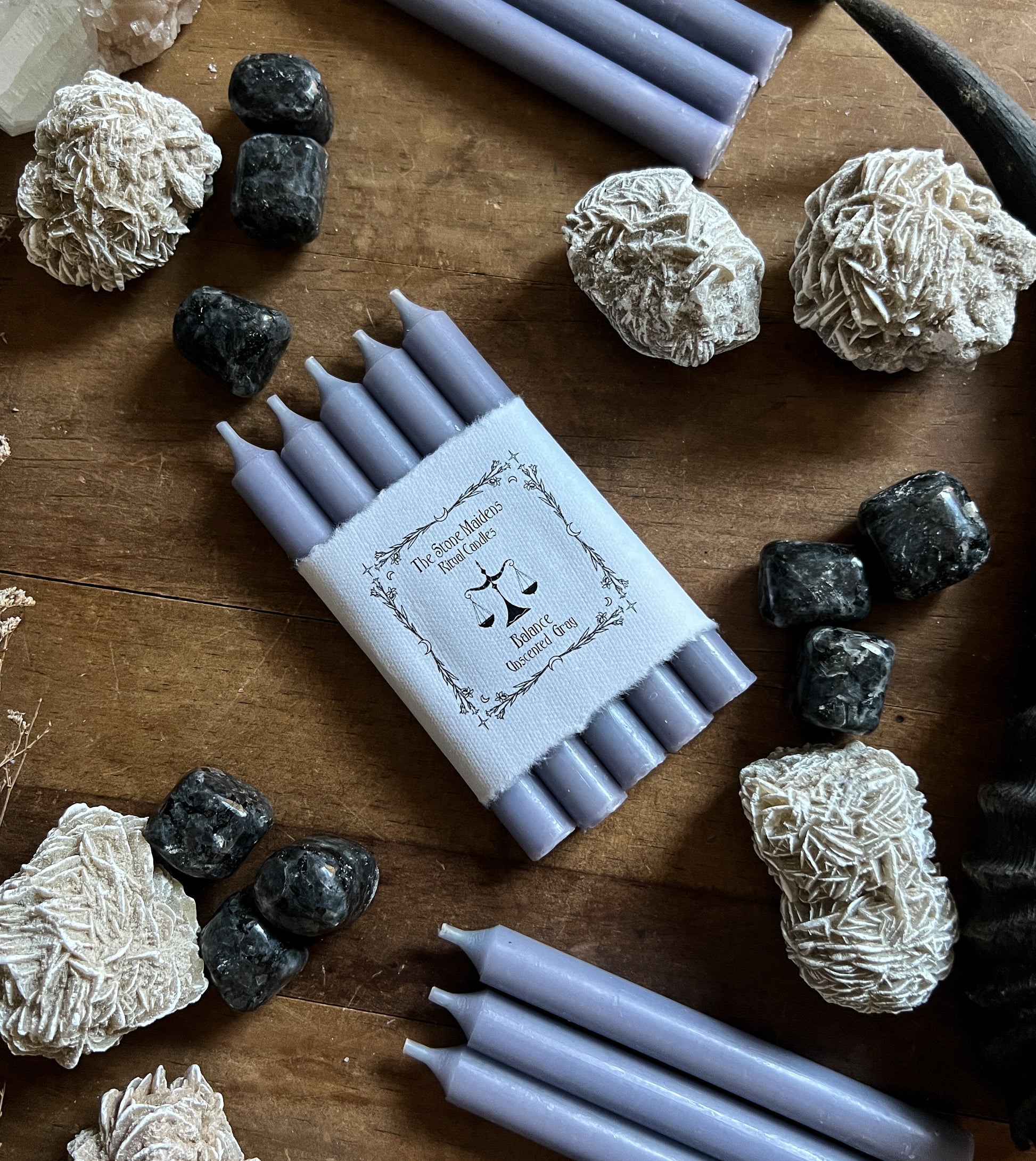 unscented grey chime candles arranged on a dark wooden altar surrounded by crystals, sold at The Stone Maidens