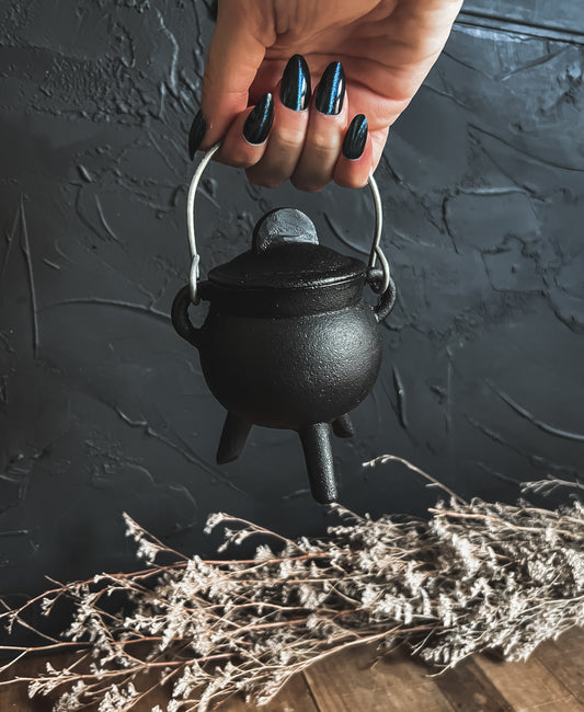 Close-up photograph of a small black cast iron cauldron, perfect for rituals, incense burning, and decorative accents in smaller spaces