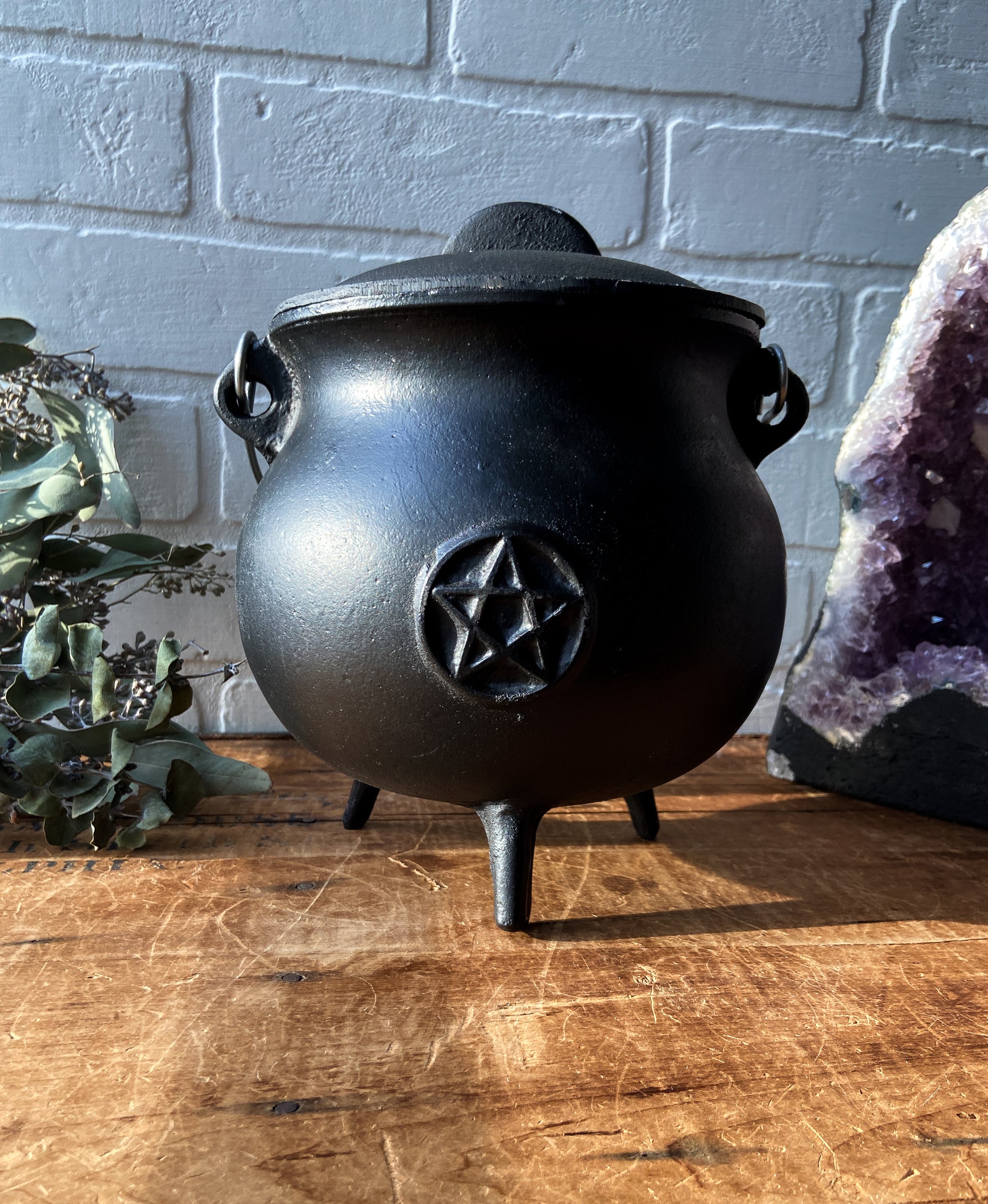 High-quality image showcasing a black cast iron cauldron, ideal for brewing potions, burning herbs, and embracing your inner witchy vibes