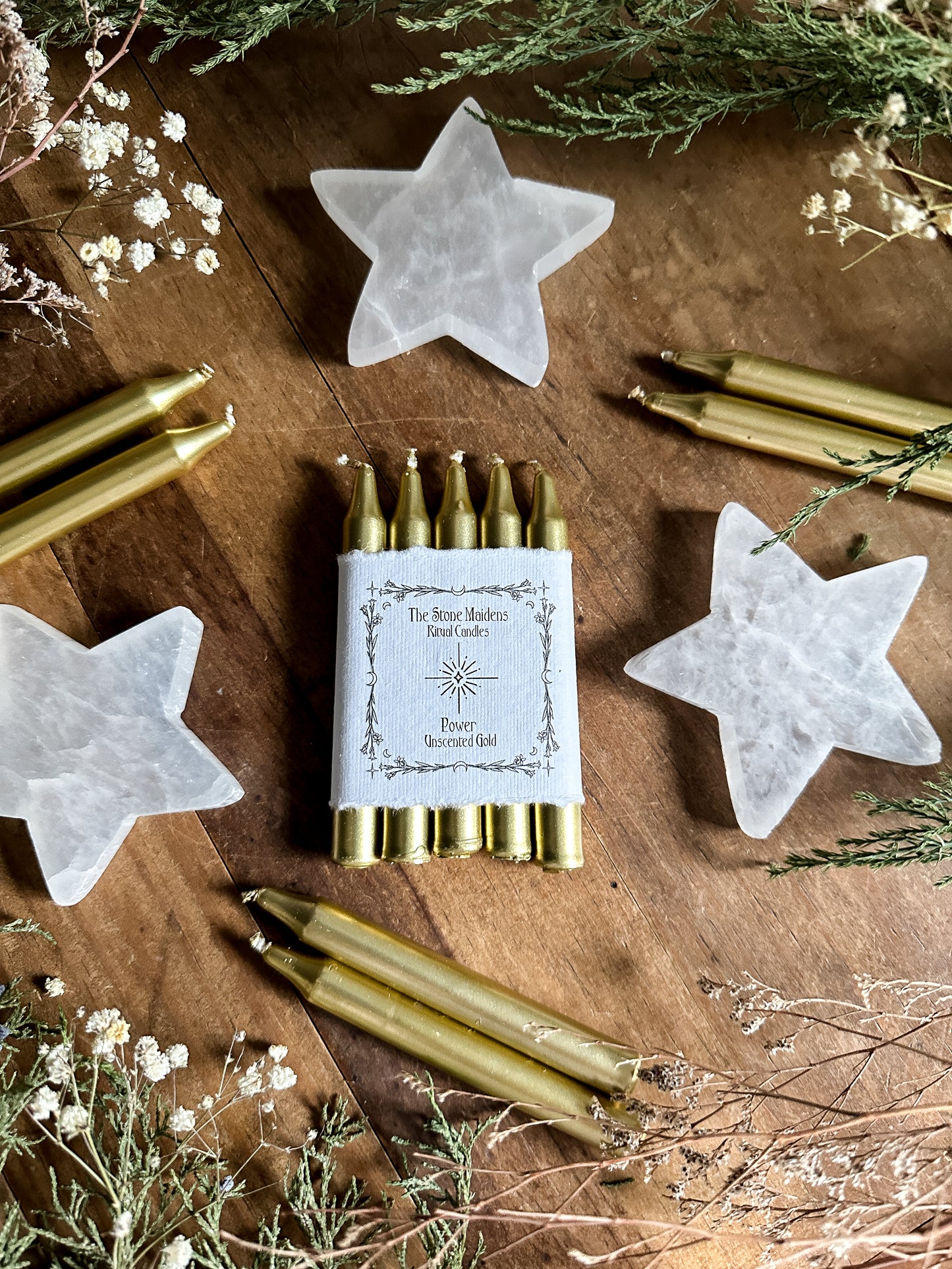 unscented Gold ritual candles arranged on a dark wooden altar surrounded by crystals, sold at The Stone Maidens