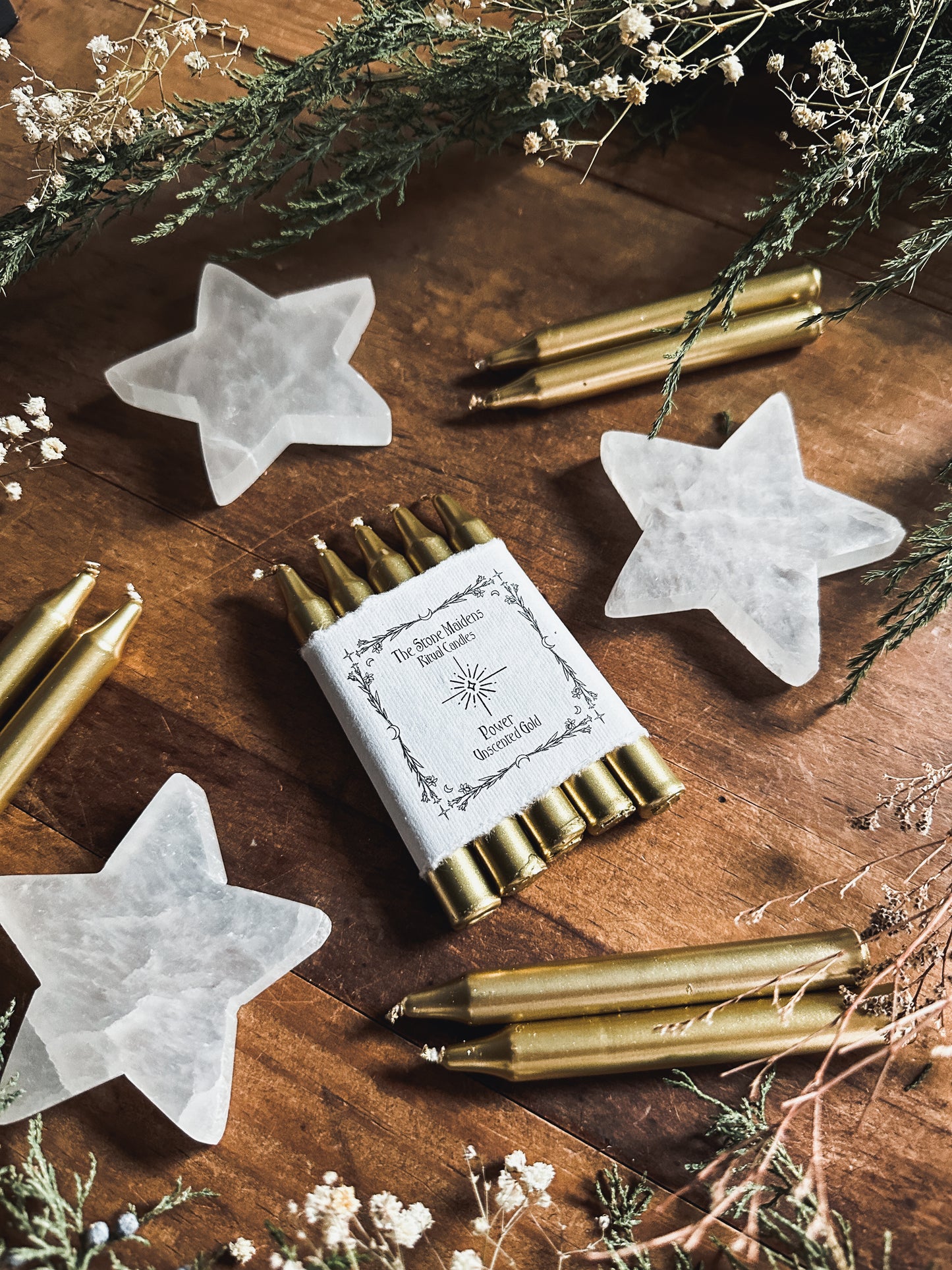 unscented Gold Chime candles arranged on a dark wooden altar surrounded by crystals, sold at The Stone Maidens