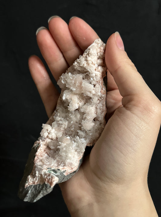 Pink Heulandite, a crystal of compassion and spiritual connection, aligns with the heart and crown chakras.