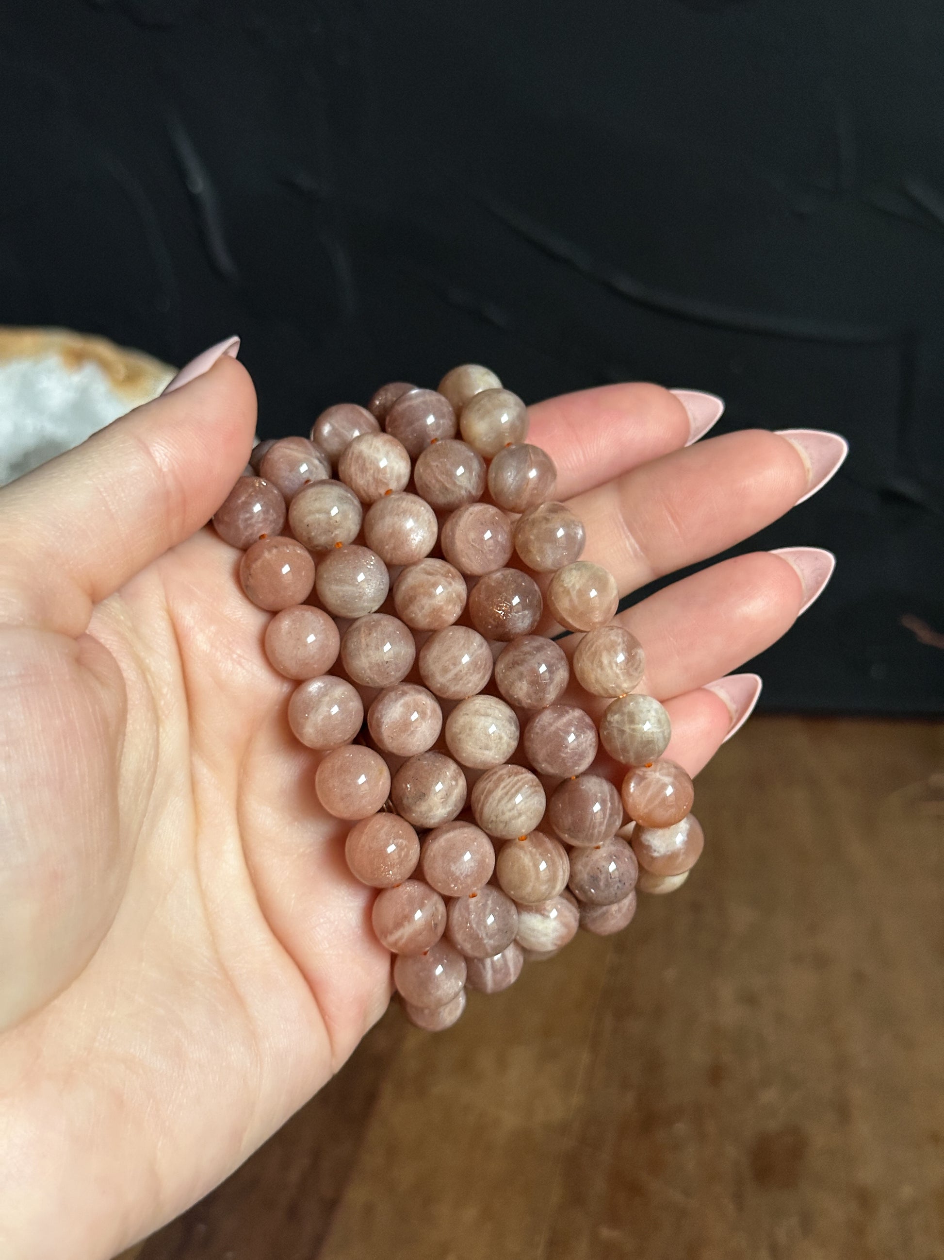 Close-up photograph of a 10mm Sunstone Bracelet, showcasing its warm, golden tones and shimmering inclusions. Found at The Stone Maidens. 