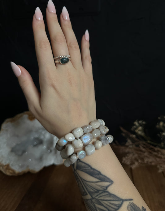 Close-up photograph of a Rainbow Moonstone Nugget Bracelet, showcasing its shimmering array of colors and organic nugget-shaped stones