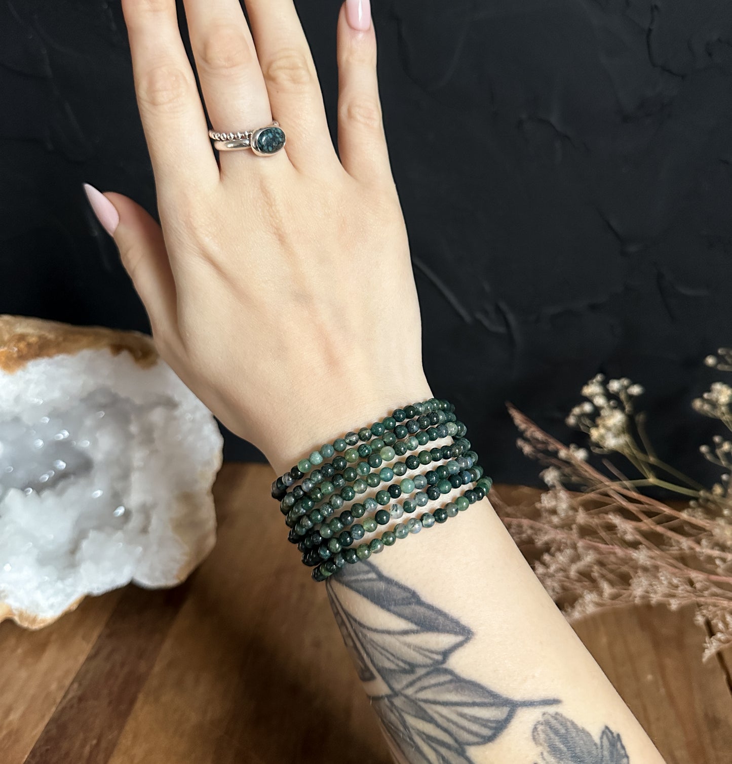 Close-up photograph of an 4mm Moss Agate Bracelet, showcasing its natural green hues and unique patterns