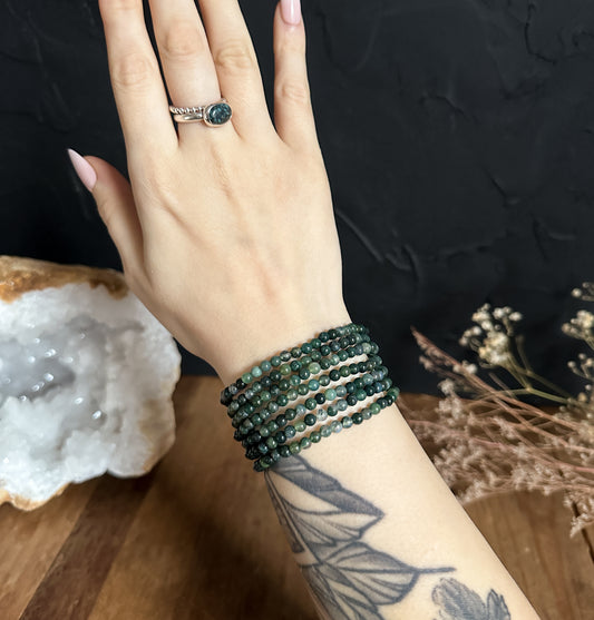 Close-up photograph of an 4mm Moss Agate Bracelet, showcasing its natural green hues and unique patterns