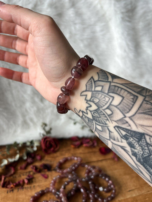 a close up photograph of The Stone Maidens genuine polished 8mm to 10mm Strawberry Quartz Crystals Bracelets