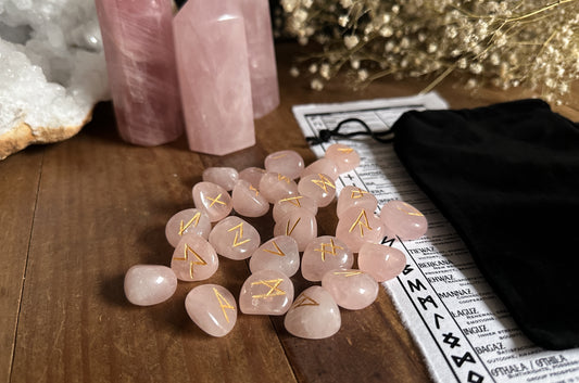 Rose Quartz Runes which contains 25pc Elder Futhark Runes, that come in a black velvet bag with a printed out meaning guide on handmade cotton paper.