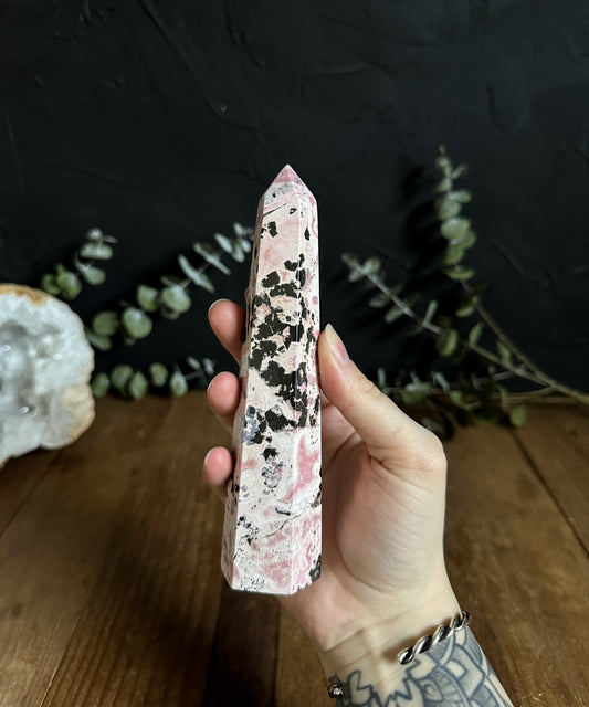 Large Rhodonite Tower, a crystal of compassion and emotional healing, aligns with the heart chakra.