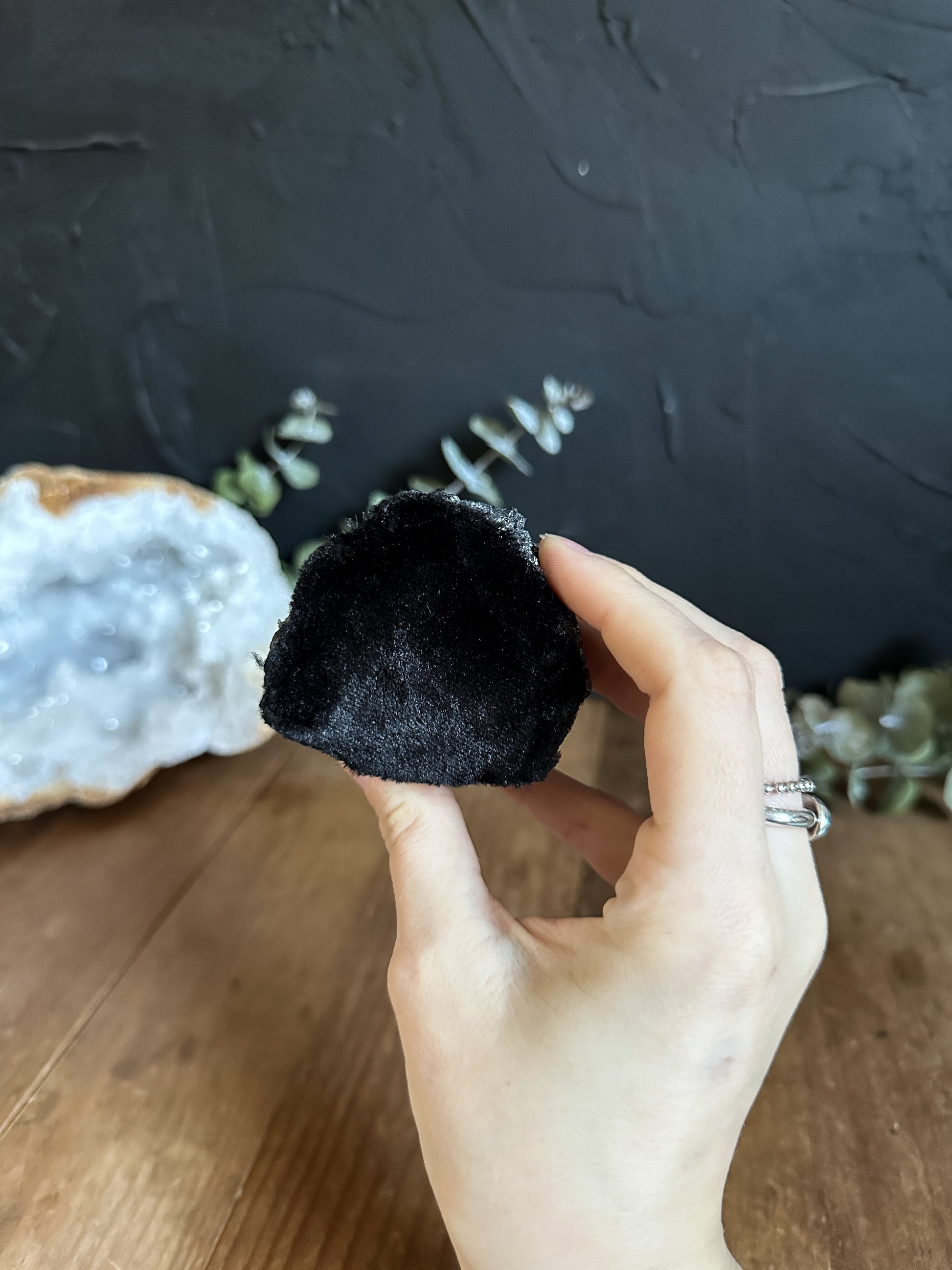 Black Tourmaline Chunk. The top is semi polished with the sides left raw.  It also has a piece of velvet on the bottom to protect your surface