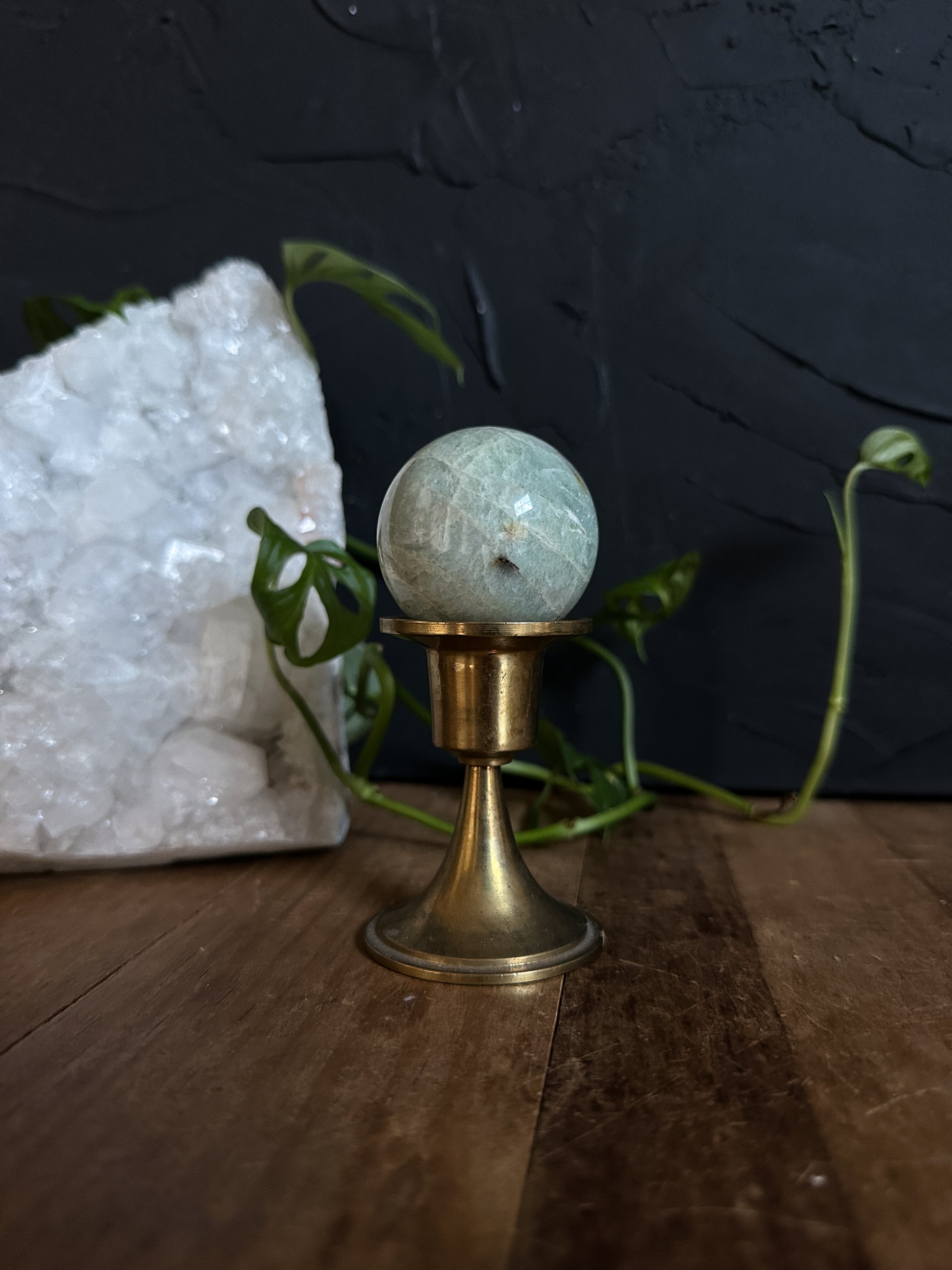 solid brass candle holder used as a crystal ball stand, perfect witchy vibe. 