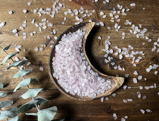 Rose Quartz Chips display in a wood moon bowl, sold at The Stone Maidens