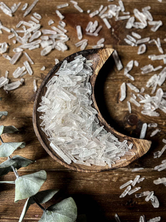 Clear Quartz Points in a wood crescent moon dish at The Stone Maidens.