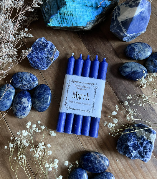 Blue Myrrh ritual candles arranged on a dark wooden altar surrounded by crystals, sold at The Stone Maidens