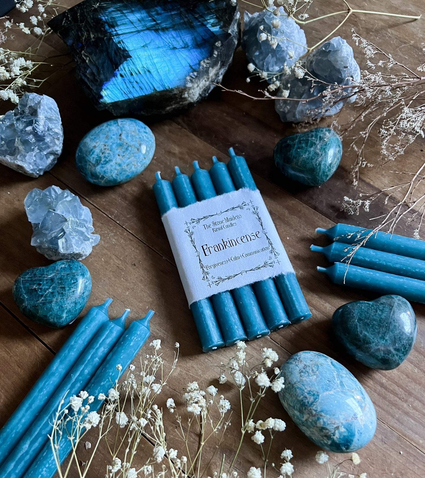 Light Blue Frankincense chime candles arranged on a dark wooden altar surrounded by crystals, sold at The Stone Maidens