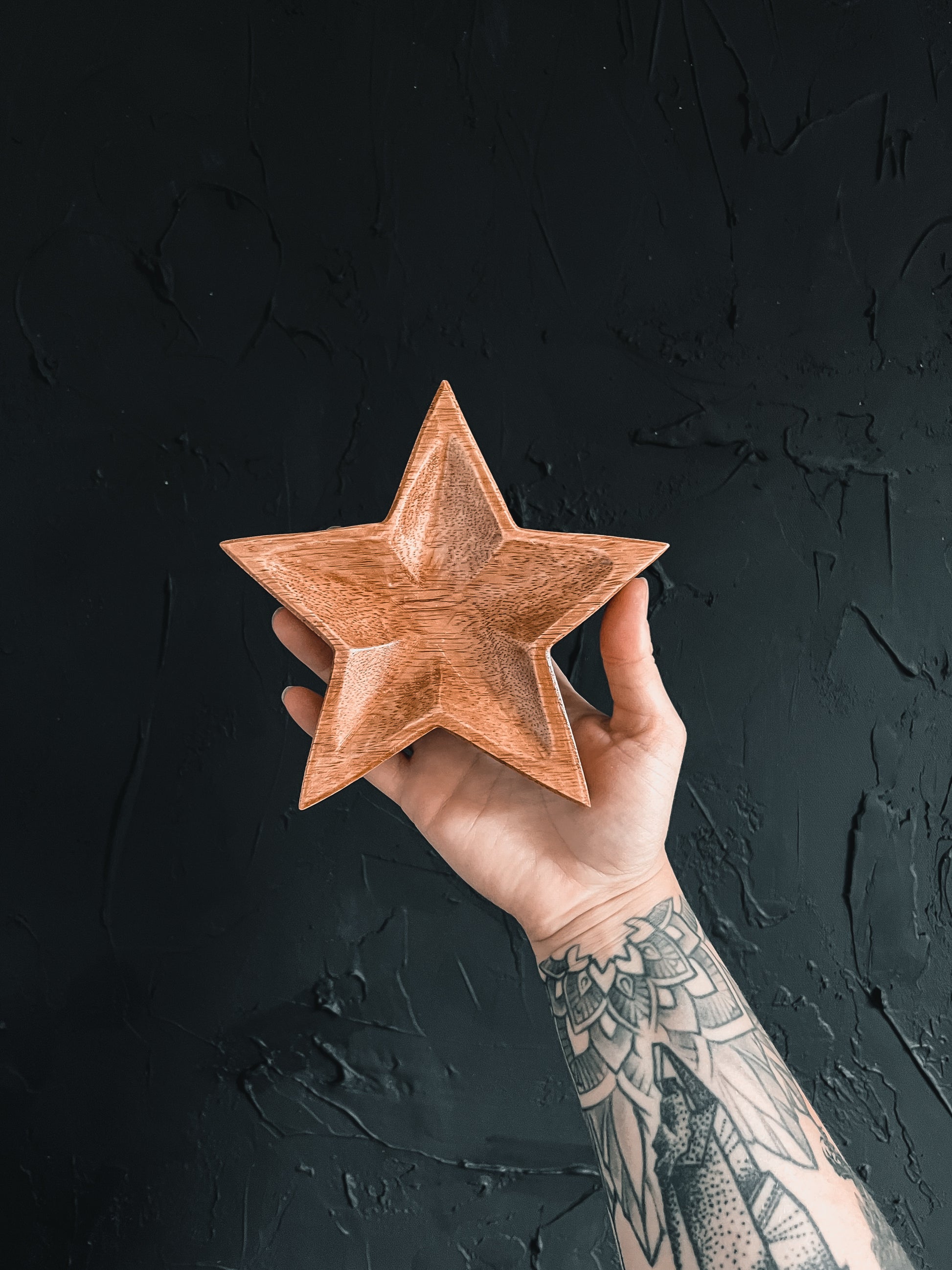 Wood star-shaped dish perfect for holding small items or adding a touch of rustic charm to your home decor.