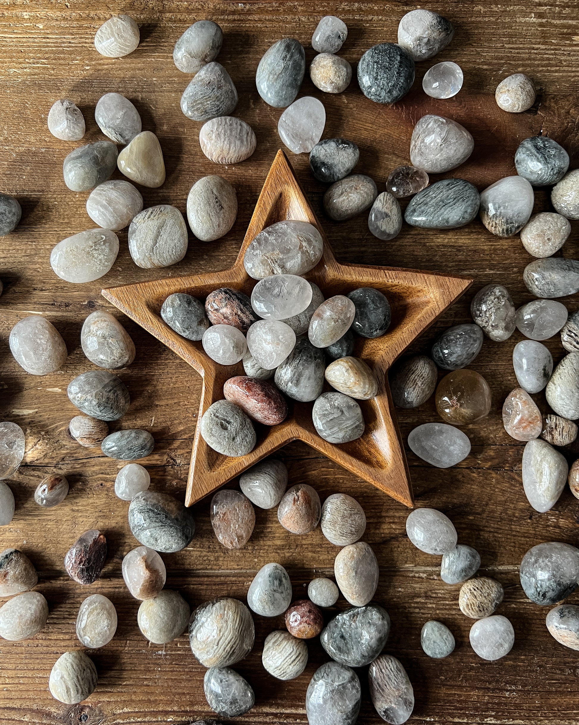 The Stone Maidens displaying gorgeous Tumbled Thousand Layered Quartz Stones with a star bowl.