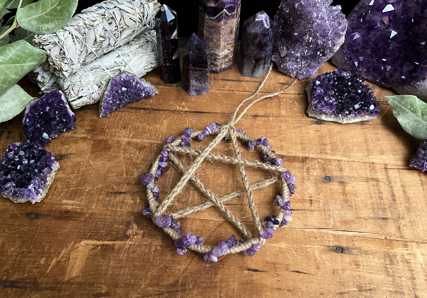 handcrafted  beautiful Amethyst Pentacle Wall Hanging by The Stone Maidens. Displayed with different amethyst crystals.