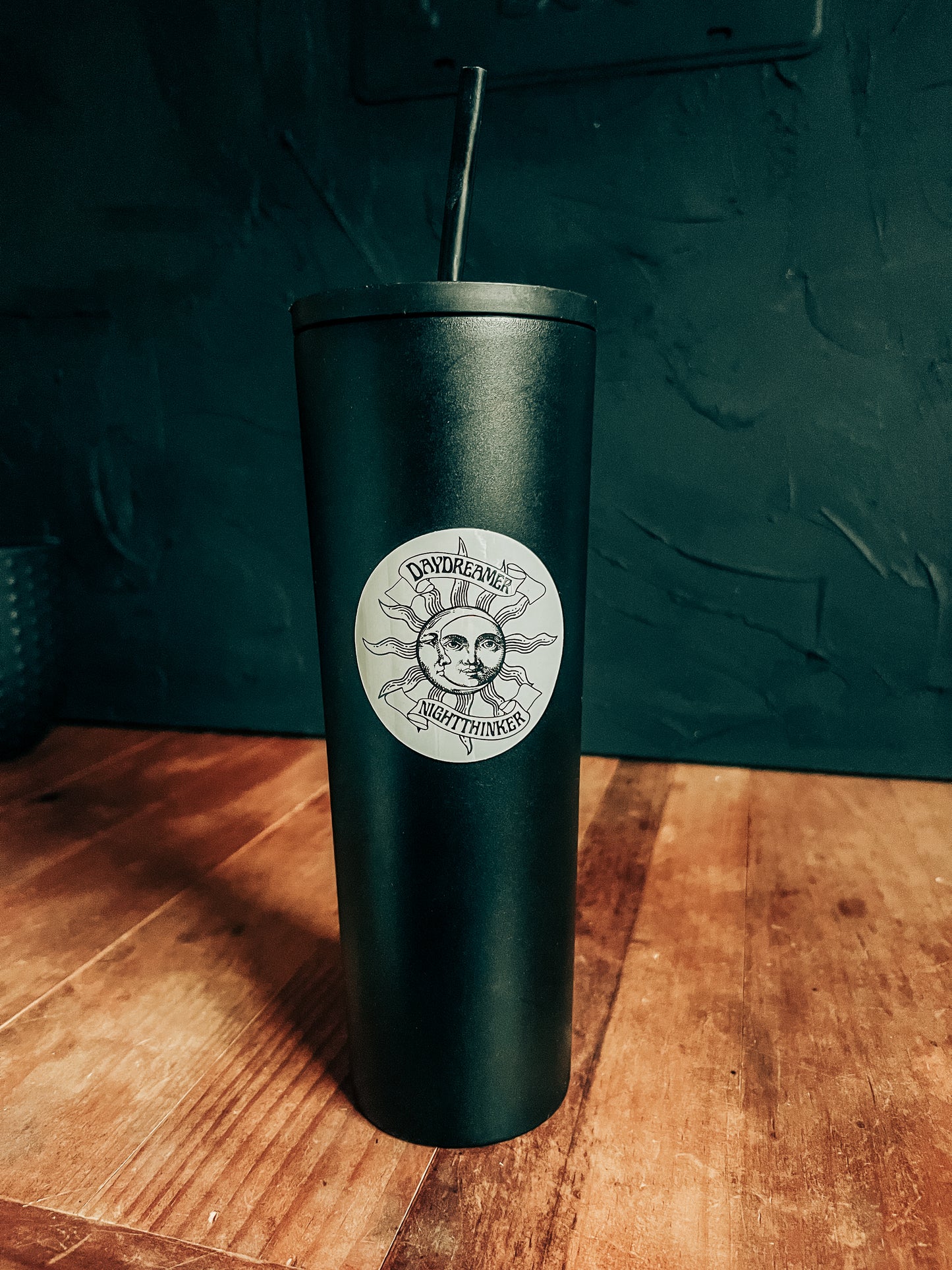 Day Dreamer Night Thinker Sticker on a reusable black water bottle.