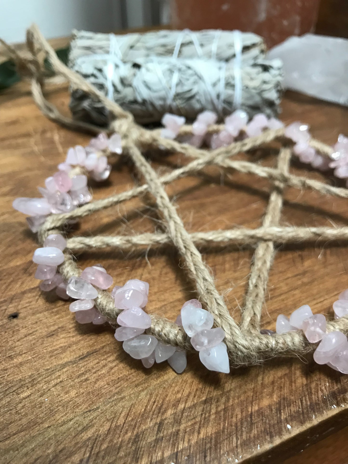 a close up image of a Rose Quartz Pentacle Wall Hanging made by The Stone Maidens.
