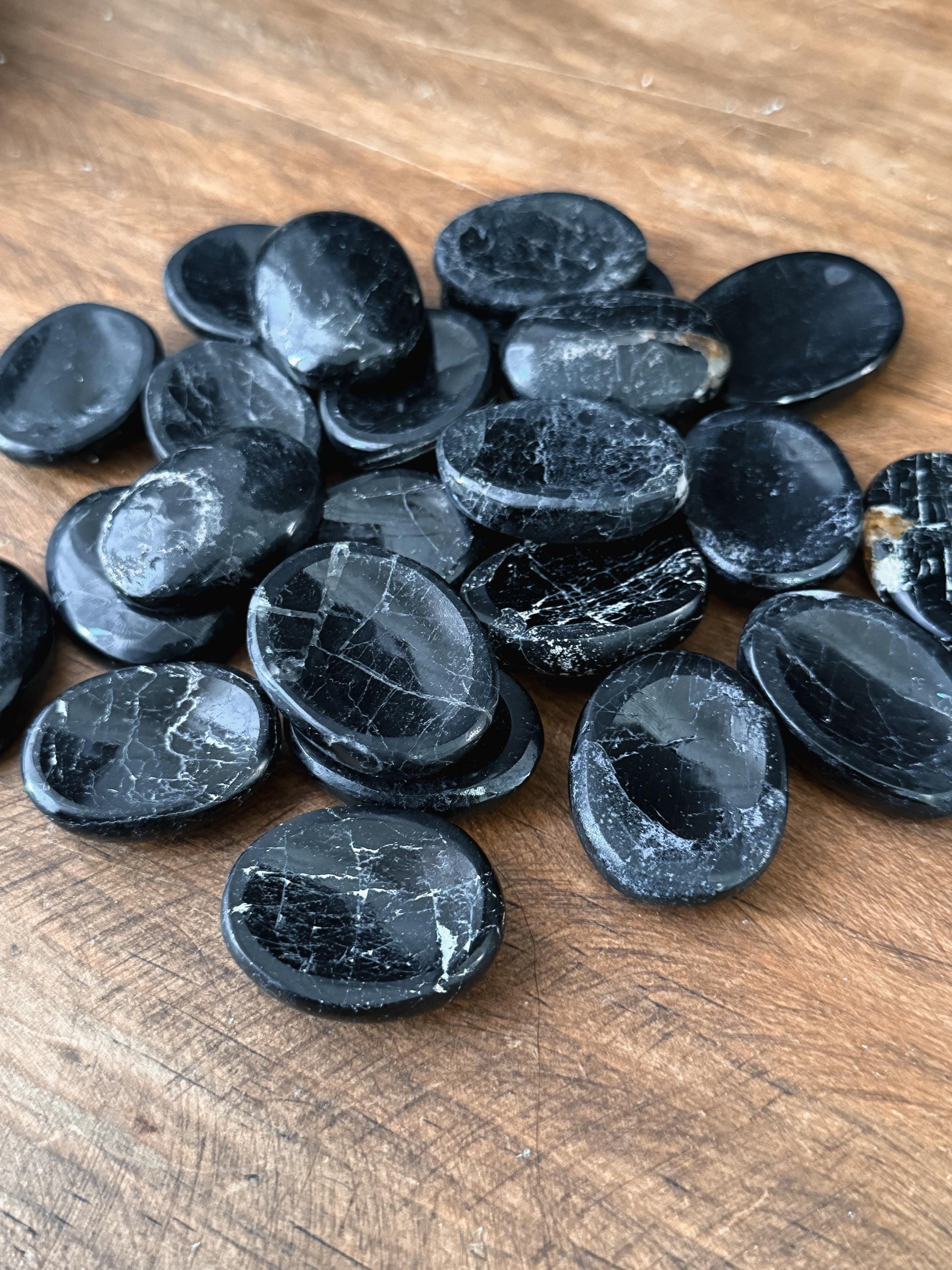 a group shot of The Stone Maidens Black Tourmaline Worry Stones 