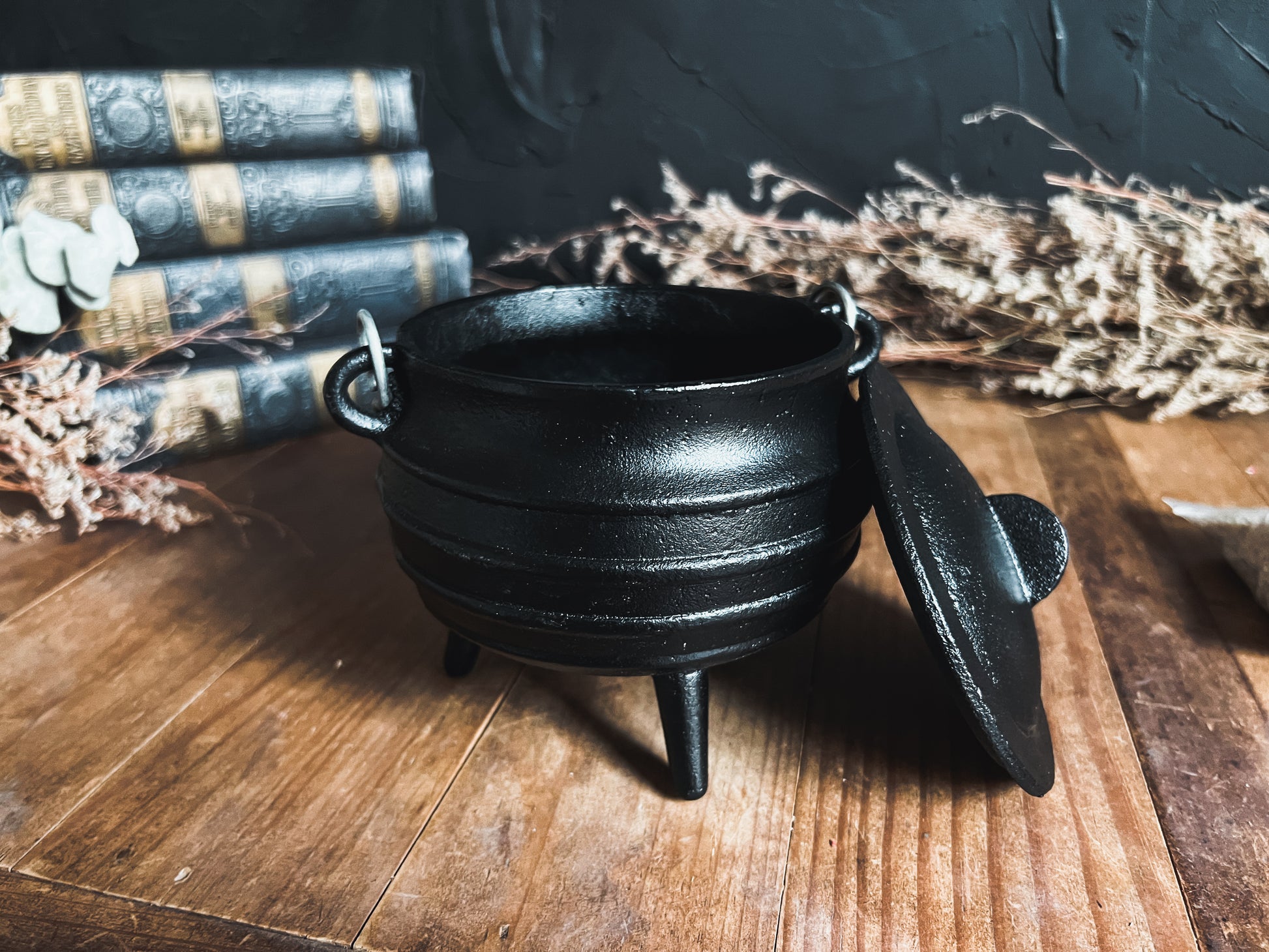 Close-up photograph of a black cast iron cauldron, perfect for rituals, incense burning, and adding a touch of magic to your space