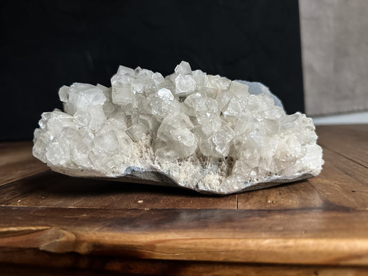 a beautiful Apophyllite Cluster, featuring sparkling, translucent crystals arranged in a mesmerizing formation. Perfect for adding natural elegance to any home decor or presenting as a thoughtful witchy gift.