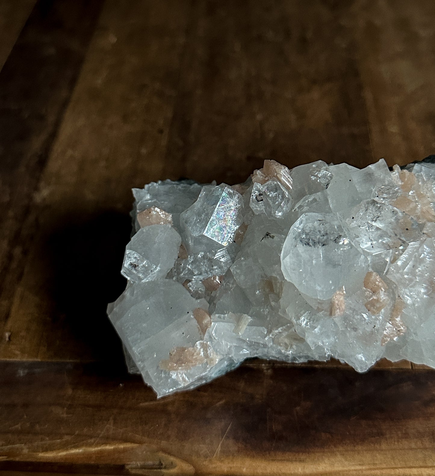 A stunning mineral specimen featuring Apophyllite crystals intertwined with delicate Pink Stilbite formations, creating a captivating contrast of textures and hues. Ideal for both enhancing home decor and delighting as a unique gift