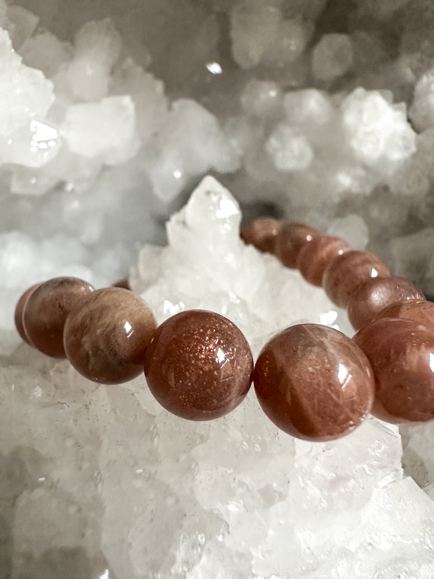 Close-up photograph of a 10mm Sunstone Bracelet, showcasing its warm, golden tones and shimmering inclusions!