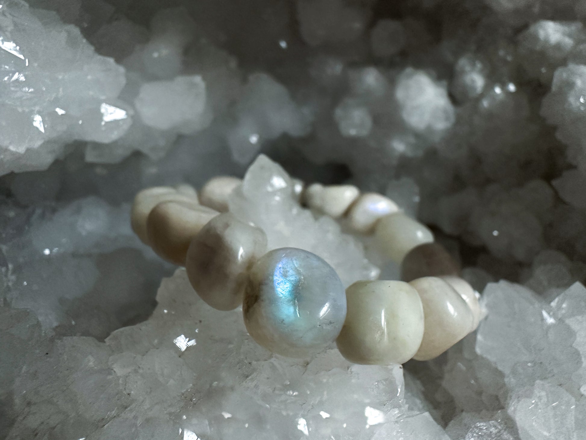 Close-up photograph of a Rainbow Moonstone Nugget Bracelet, showcasing its shimmering array of colors and organic nugget-shaped stones from The Stone Maidens.