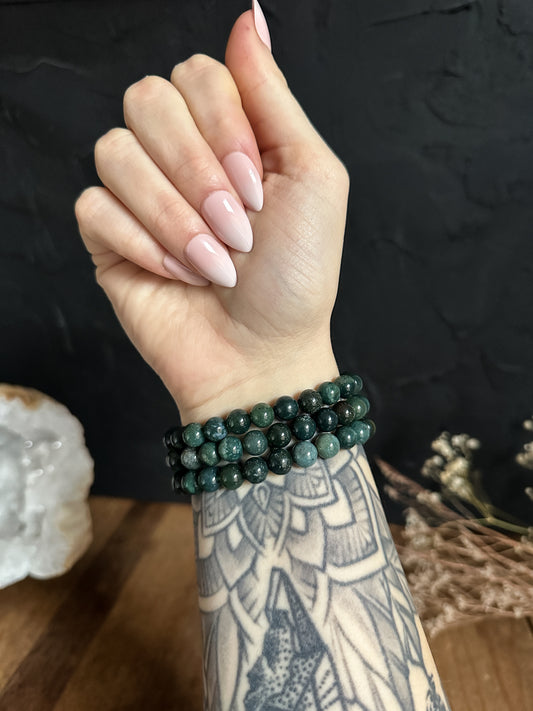 a gorgeous image of The Stone Maidens wearing a 8mm Moss Agate Bracelets.