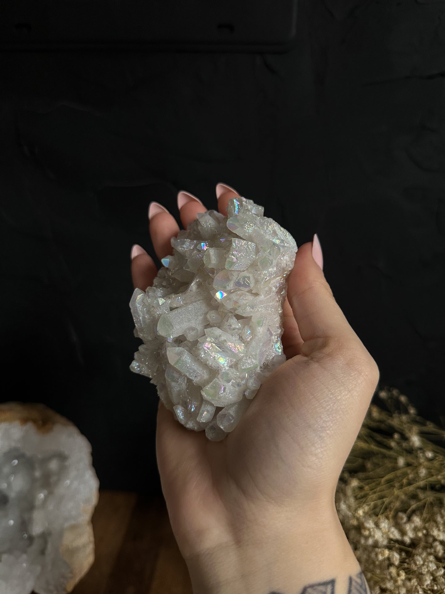 Glimmering Angel Aura Quartz Clusters, adorned with iridescent pastel hues, evoke a sense of celestial beauty. Their ethereal charm makes them an enchanting addition to any space or a cherished gift for those seeking serenity and harmony.