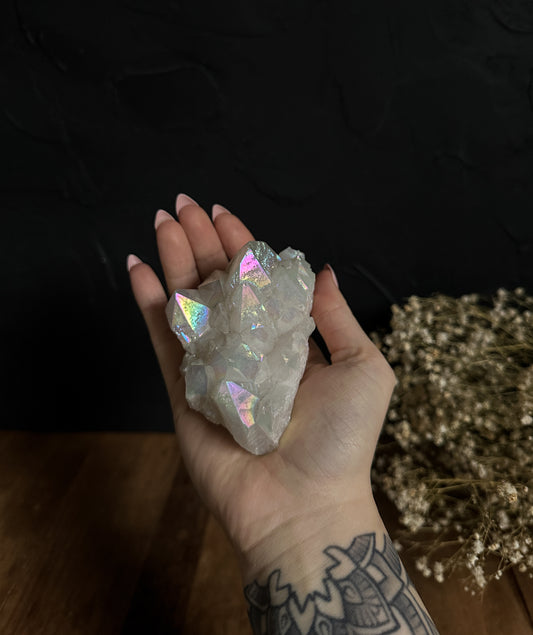 An enchanting Angel Aura Quartz Cluster, radiating a soft, ethereal glow, perfect for spiritual practice and decor