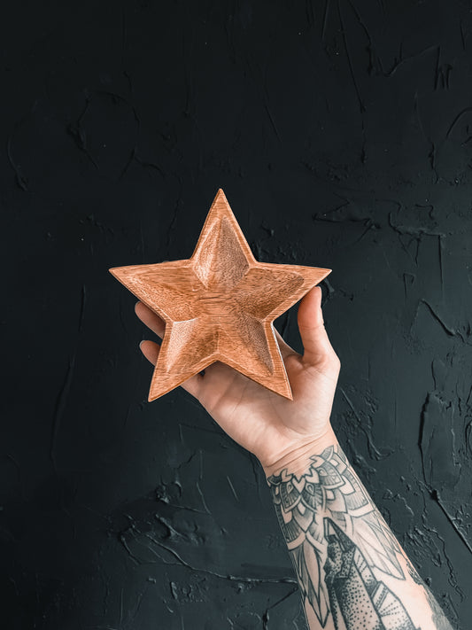 Wood star-shaped dish perfect for holding small items or adding a touch of rustic charm to your home decor. 