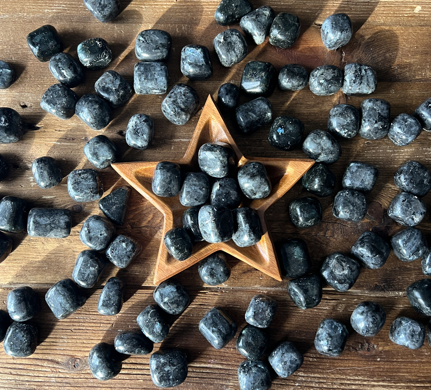 Gorgeous Large Larvikite Tumbled Stones displayed in a wood star bowl at The Stone Maidens