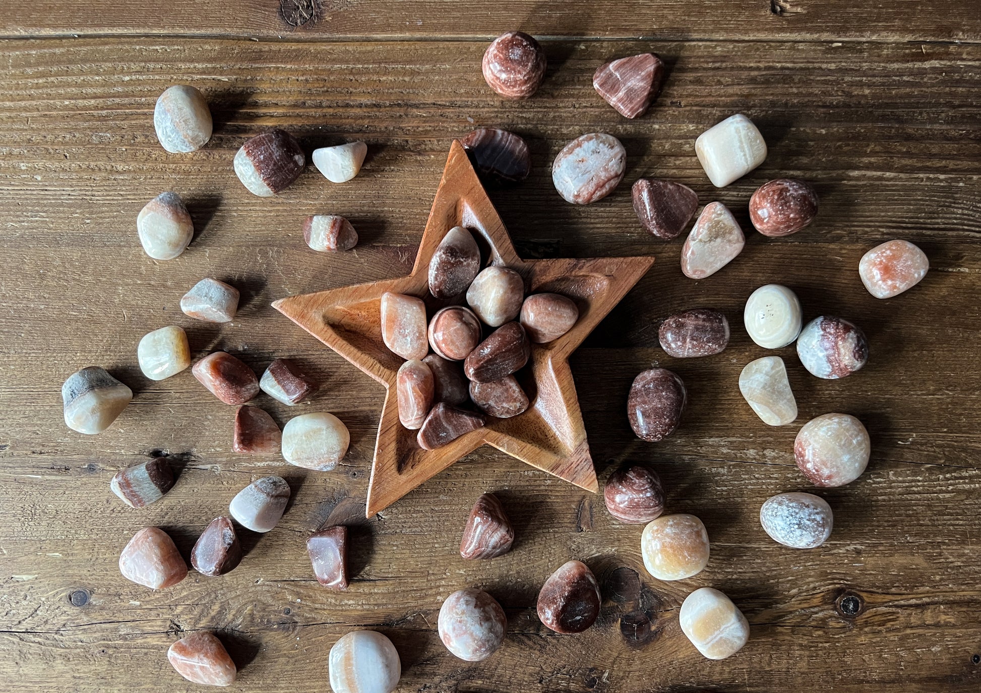 Tumbled Red Aragonite Stones, each intuitively chosen for its unique energy at The Stone Maidens