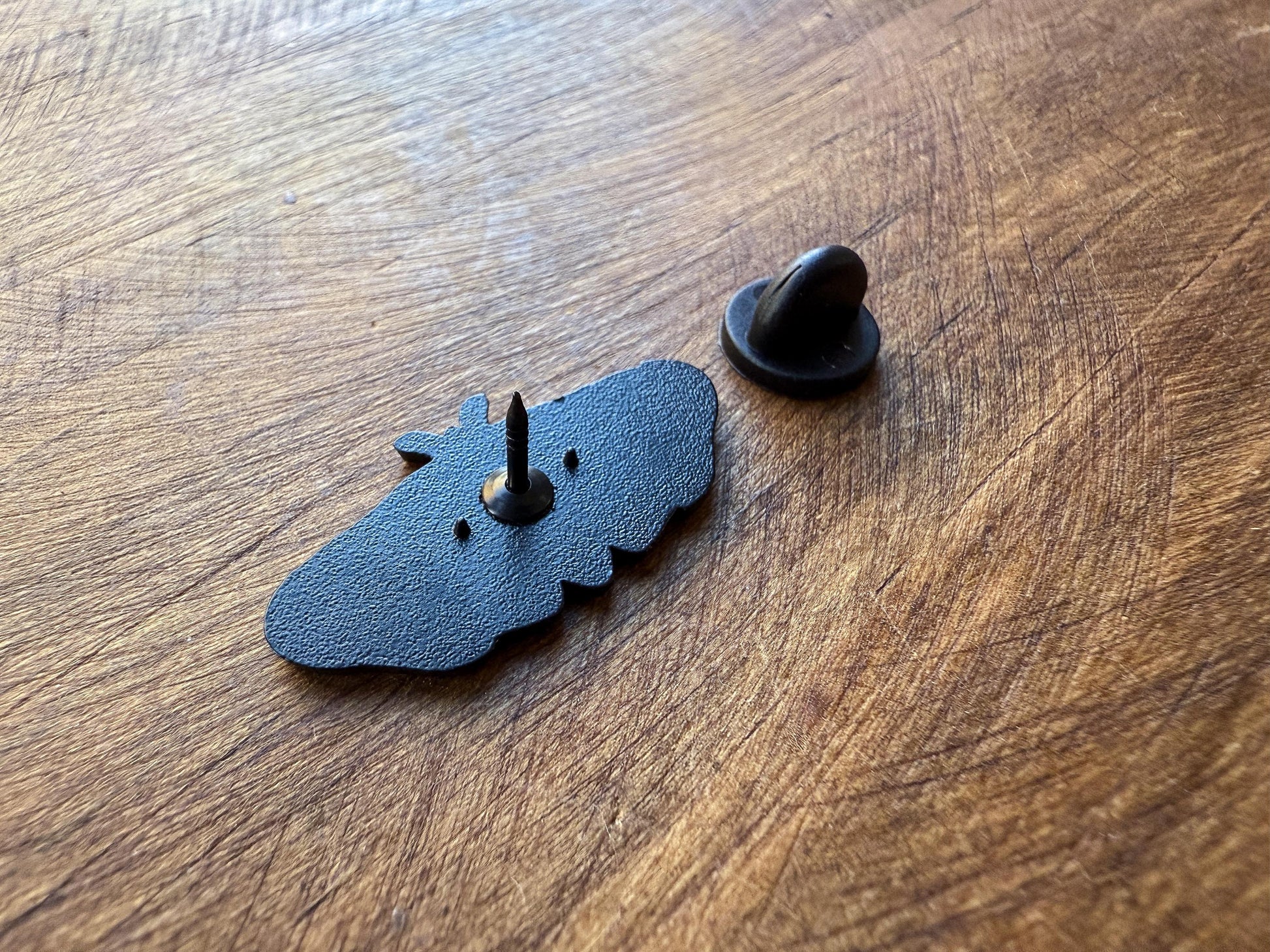 the back of the Skull Moth Enamel Pin