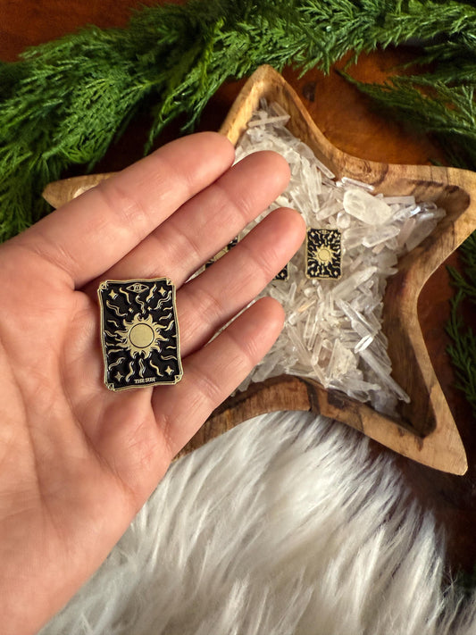 The Sun Tarot Card Enamel Pin in the hand of The Stone Maidens 