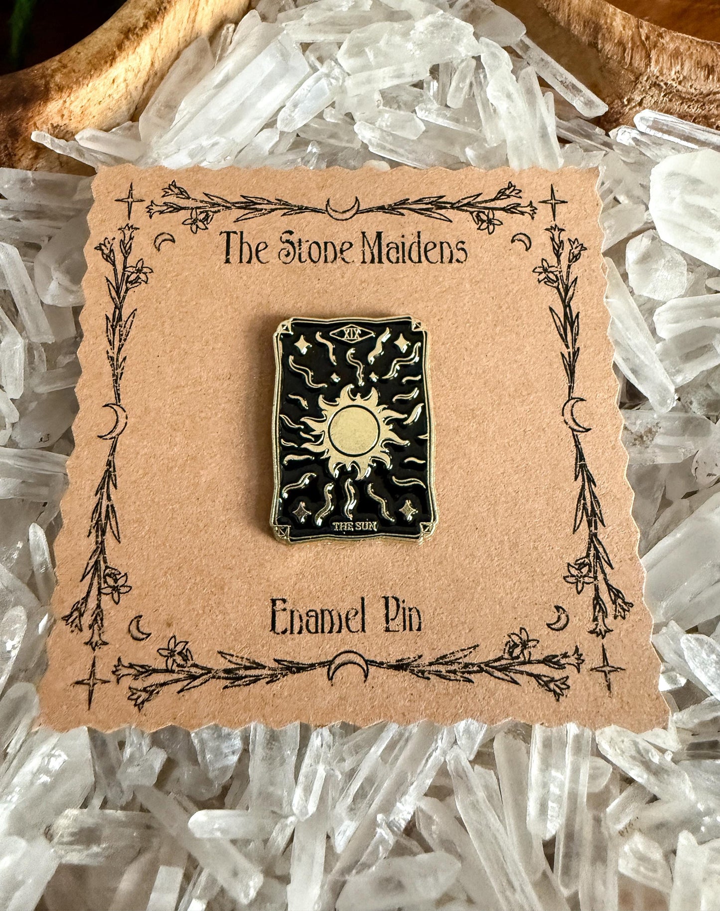 a close up shot of The Sun Tarot Card Enamel Pin at The Stone Maidens 