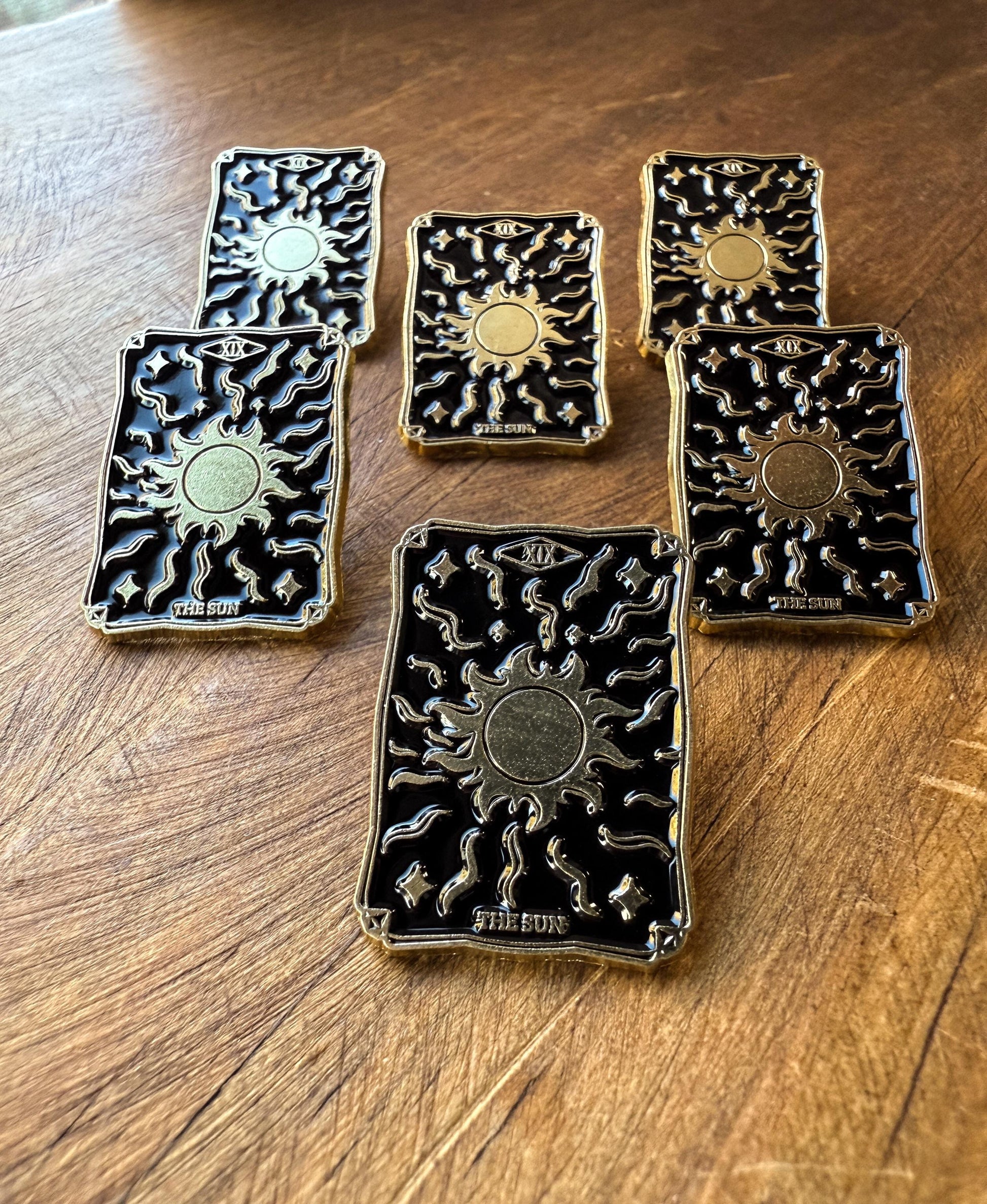 a group shot of The Sun Tarot Card Enamel Pins at the Stone Maidens 