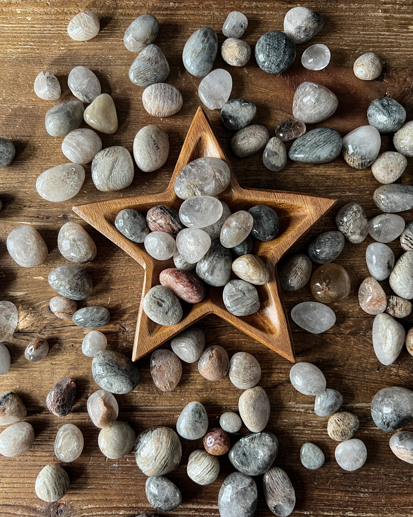 The Stone Maidens displaying gorgeous Tumbled Thousand Layered Quartz Stones with a star bowl. 