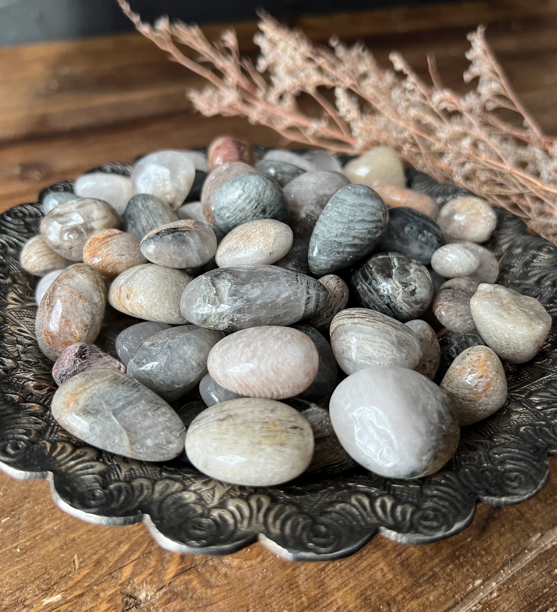 a close up shot of Tumbled Thousand Layer Quartz Stones at The Stone Maidens